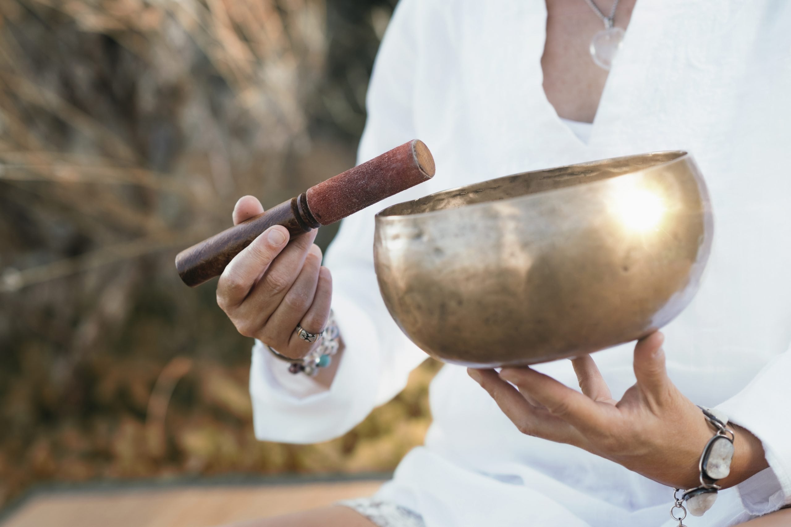 person using sound bowls